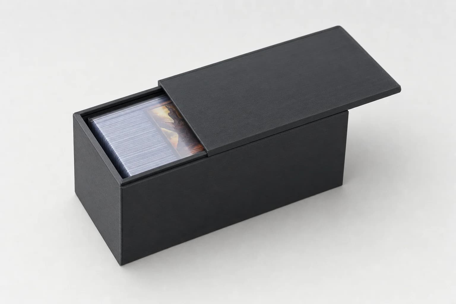 Black FDM-printed sliding-lid deck box holding sleeved cards